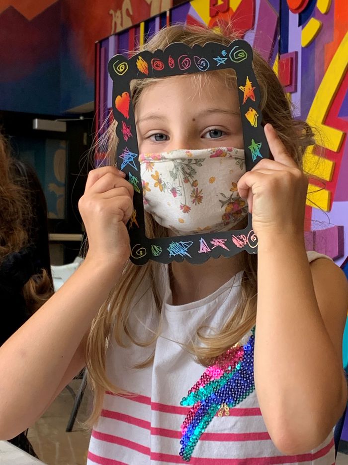 young girl displaying her custom photo frame