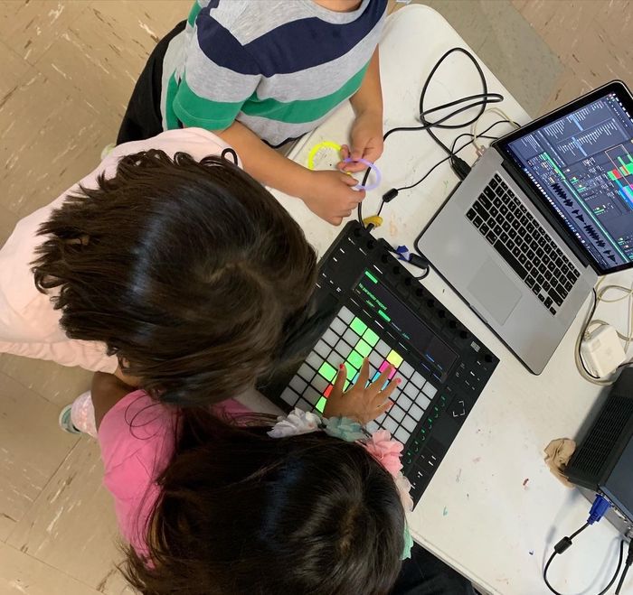 3 children making music on a laptop