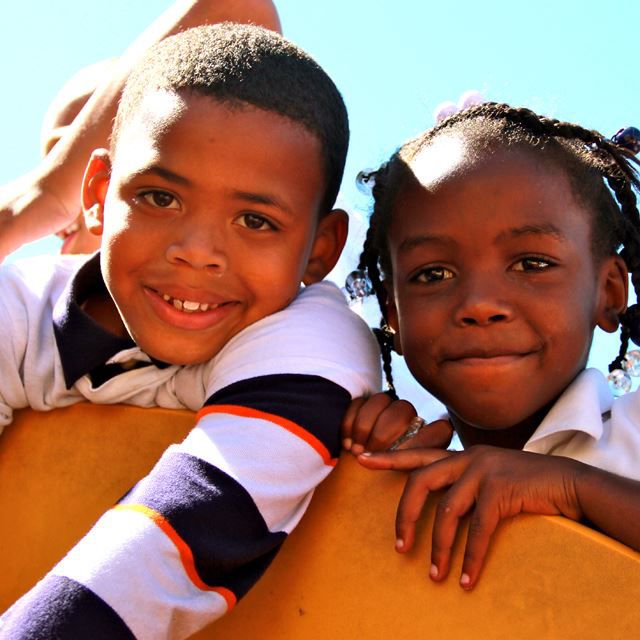 Boy and girl smiling on playground