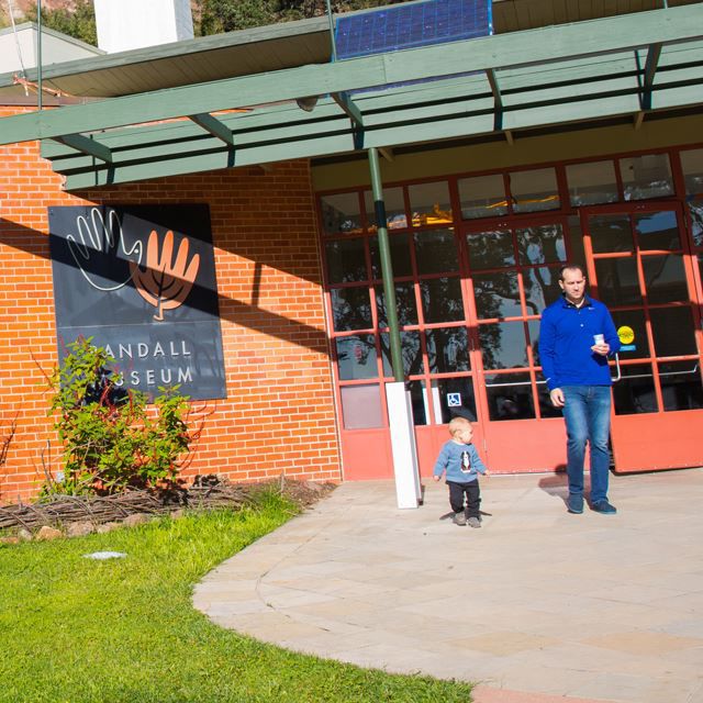 Man and child standing outside Randall Museum