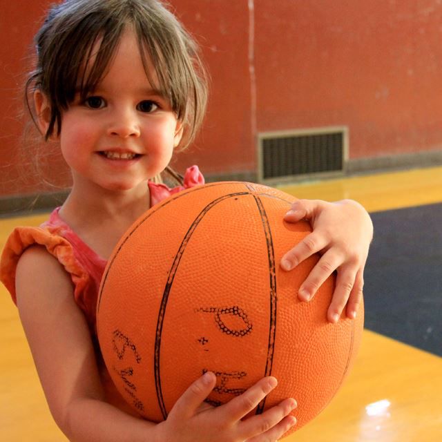 Little girl holding a basketball