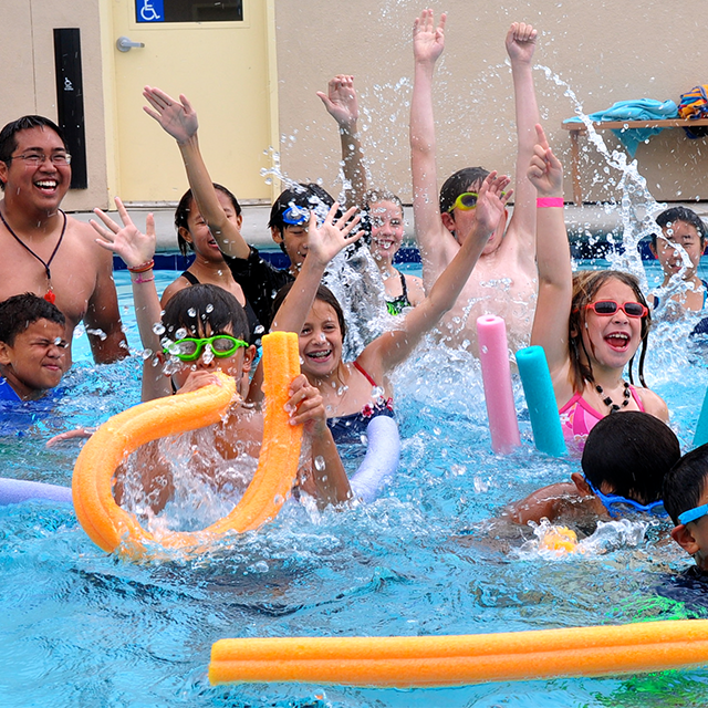 Kids in the pool with pool noodles 3